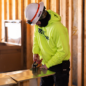 a construction worker cutting sheet metal