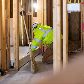 Construction worker installing plumbing in a house