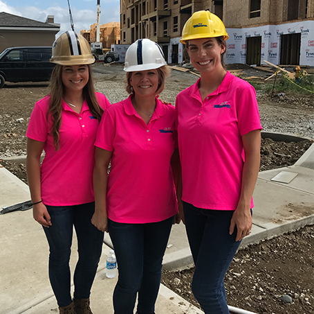 Females in hard hats on a work site